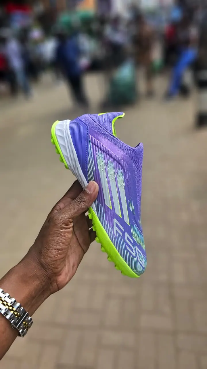 Adidas F50 League Laceless Turf soccer shoes in Purple Rush, Lucid Lemon, and white.